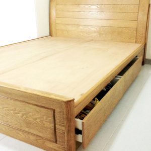 A storage bed made of solid plywood and finished with ash veneers and stained a light cocoa.